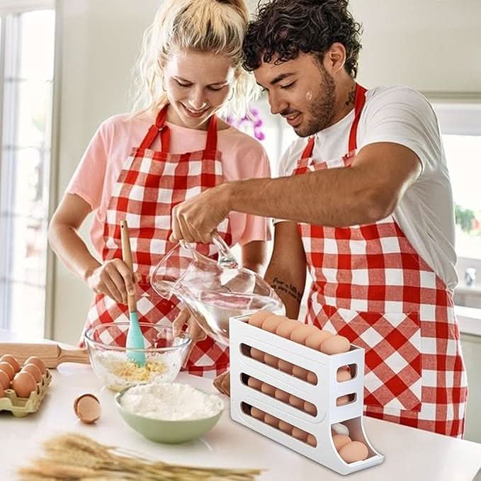 Couple wearing checkered aprons using an EggFlow Premium Refrigerator Egg Organizer in a kitchen
